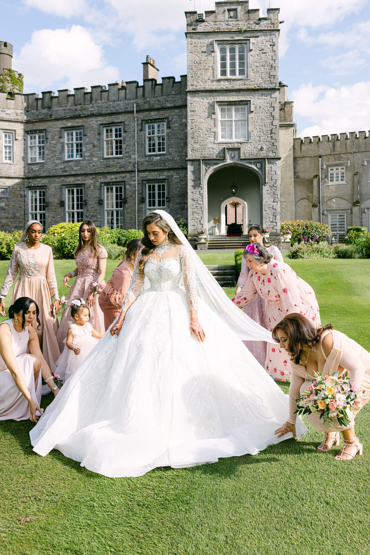 A wedding photo of a bride and her bridemaids on the lawn of Luttrellstown Castle