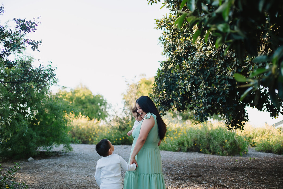 Mother showing love to her oldest child while holding her new baby in Long Beach,CA