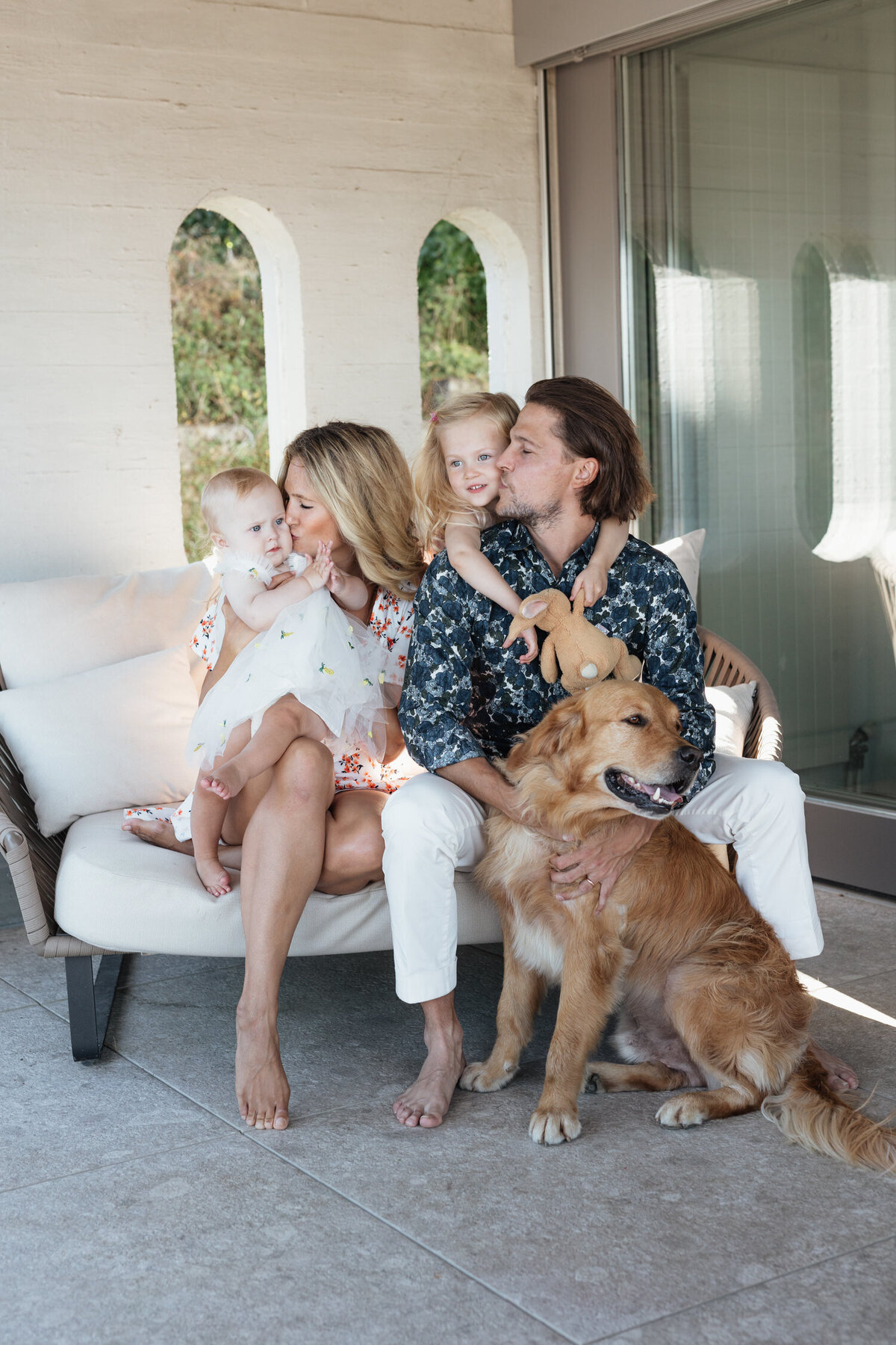 Parents smiling at kids during family photoshoot in Zug