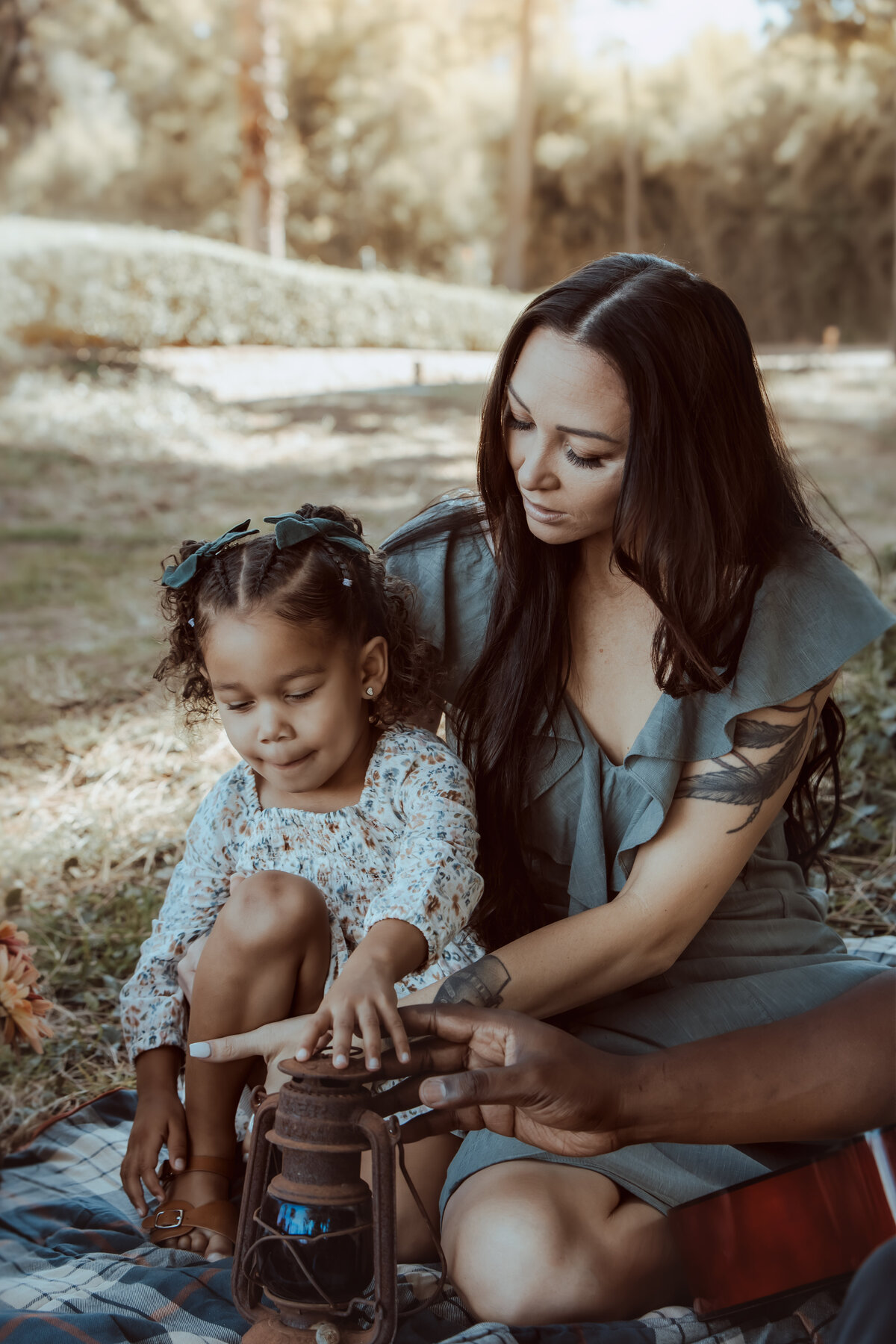 Mother Helping Daughter Explore Vintage Lantern – Prospect Park Redlands Photoshoot
