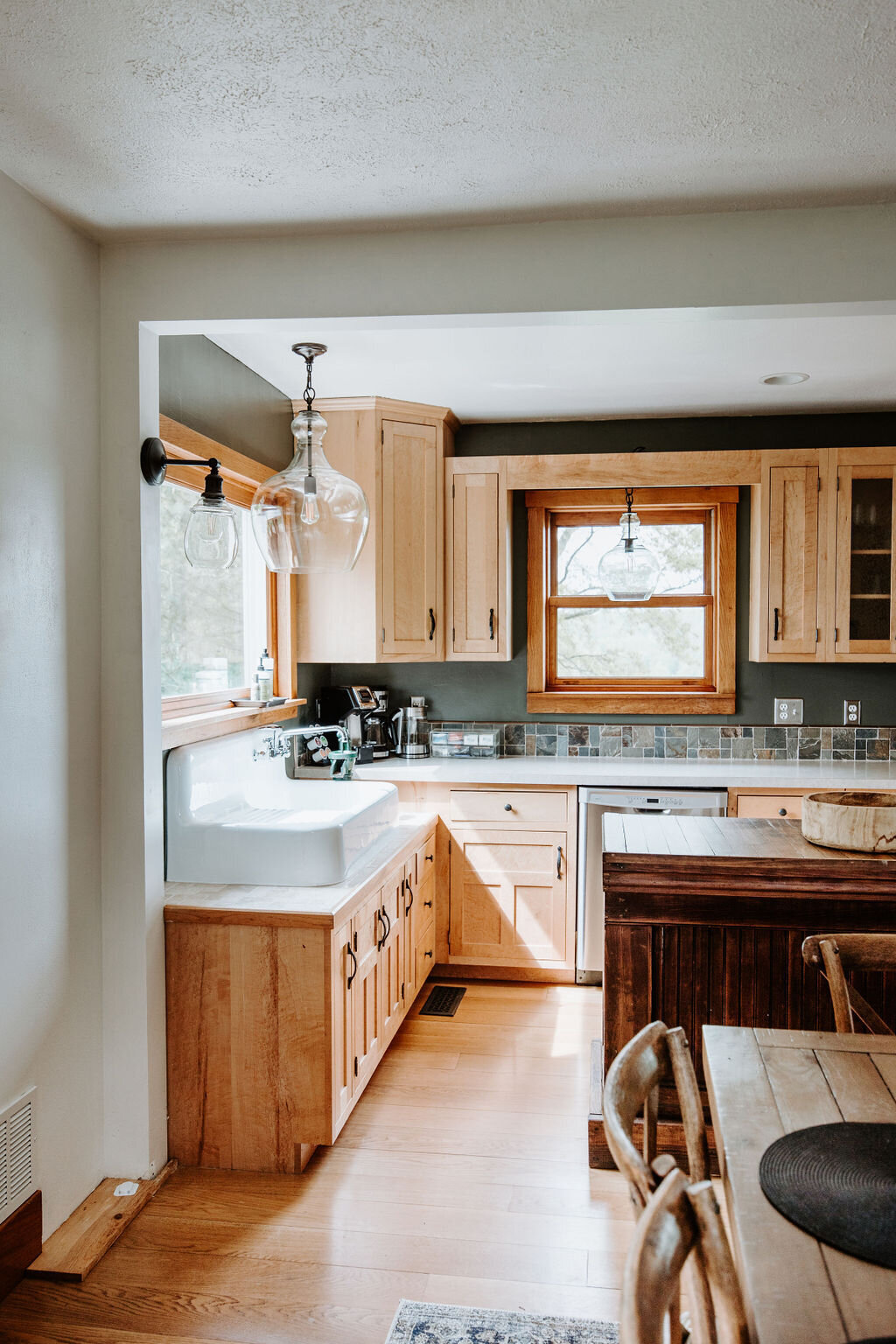 the vintage drainboard sink and glass Pottery Barn pendant lights in the kitchen of the modern farmhouse at Willowbrook wedding venue with overnight accommodations