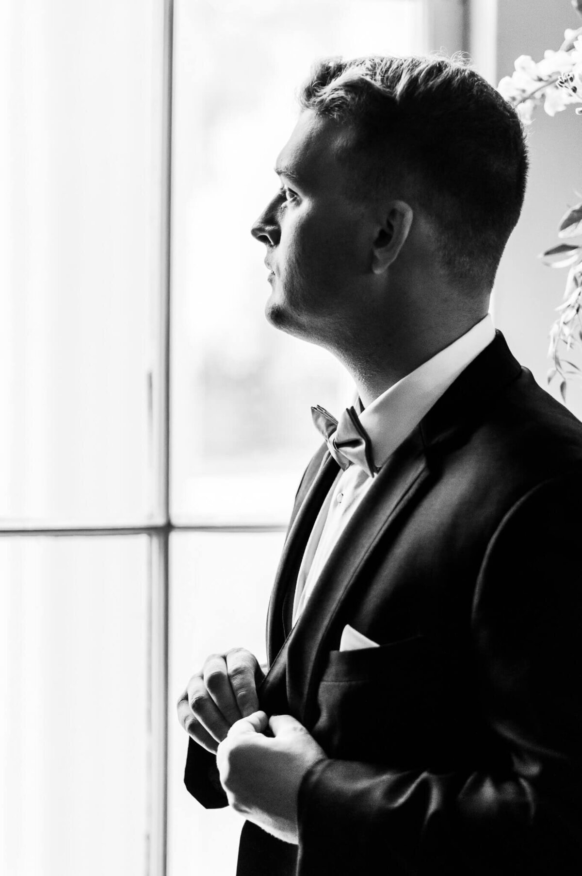 Bragg-Mitchell-Mansion-Mobile-Alabama-Wedding-Photographer-Emily-Trey-Groom-Looking-Out-Window-BW