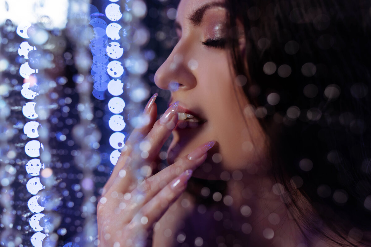 close up boudoir image of woman touching mouth in shower