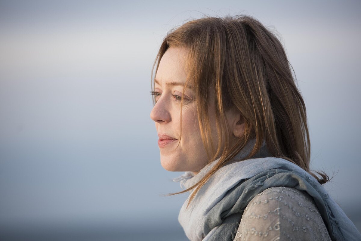 A person in a scarf looking out into the distance