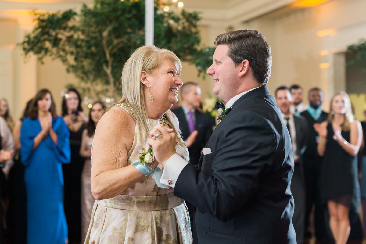 This mother son dance was both parts emotional and surprising! Photo by luxury destination wedding photographer Rebecca Cerasani.