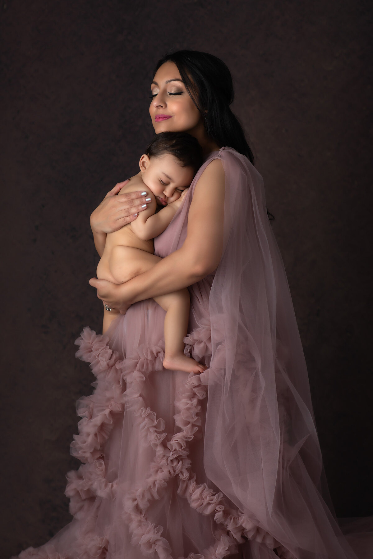 A tender moment between a mother and her baby, captured by a Dallas family photographer.
