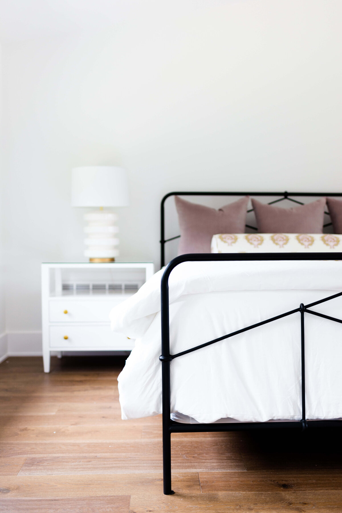 oyster creek studios building belt new build white bed and white side table with white lamp in bedroom