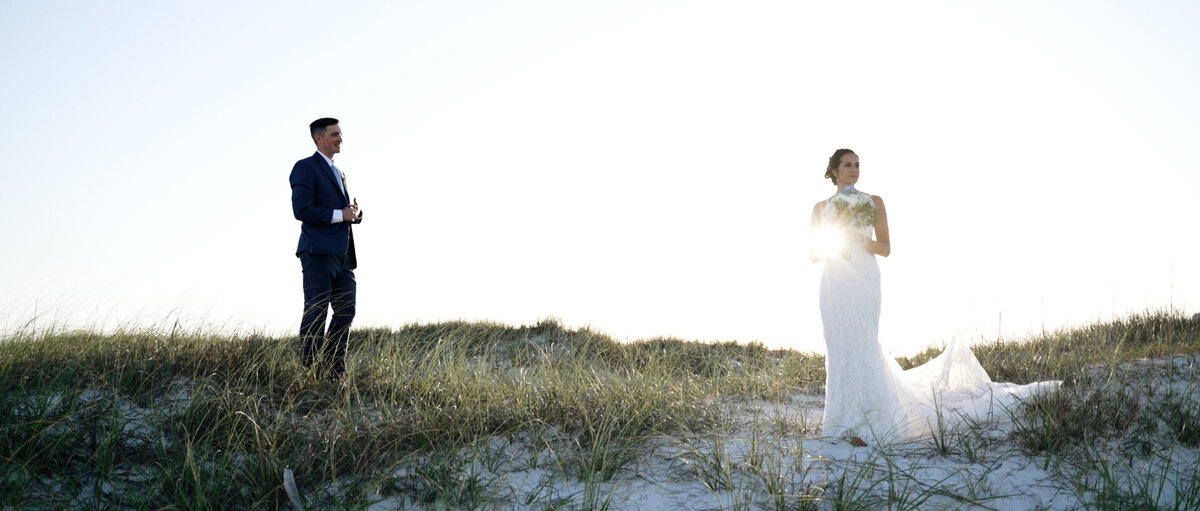 Bride and groom posing for their Destin fl wedding on the beach.