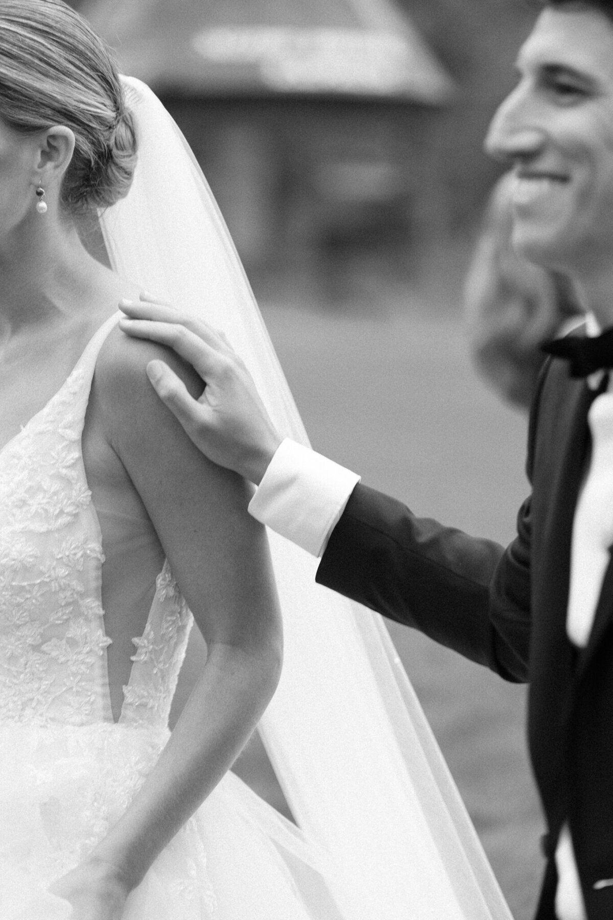 Elegant bride and groom smile while drinking champagne from coups