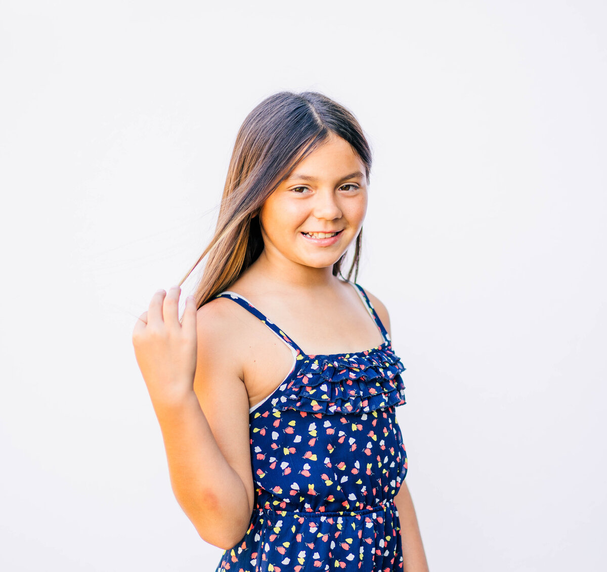 Close-up of 5th-grade girl looking at camera with gentle smile