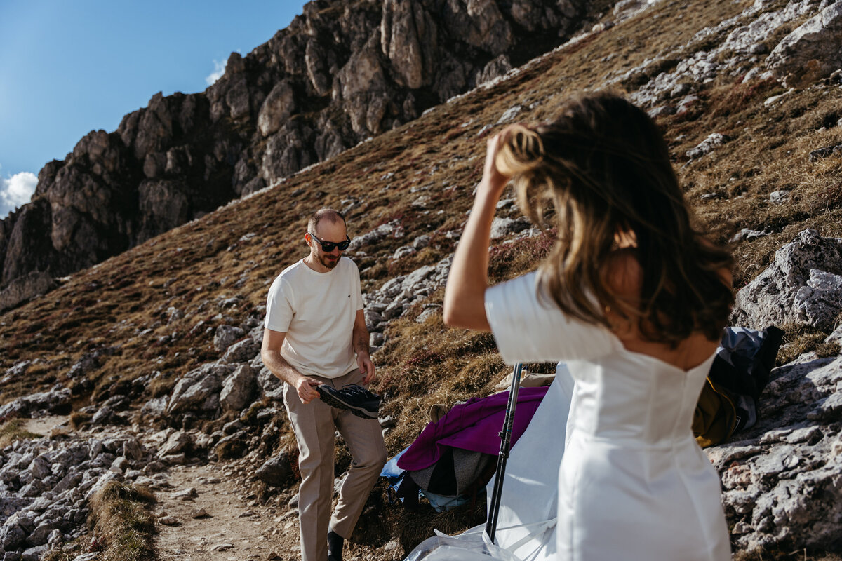 Bride adjusting hair while preparing for elopement in Dolomites