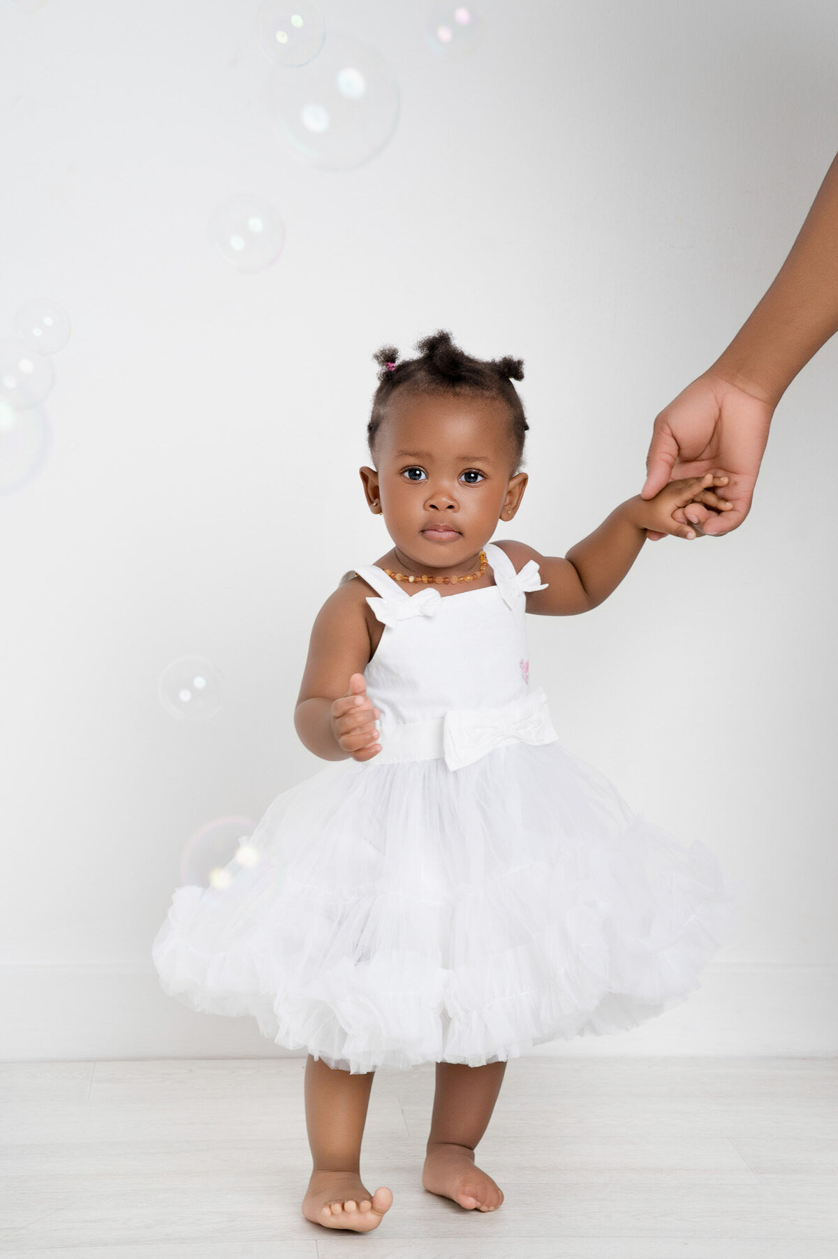 little girl holding moms hand