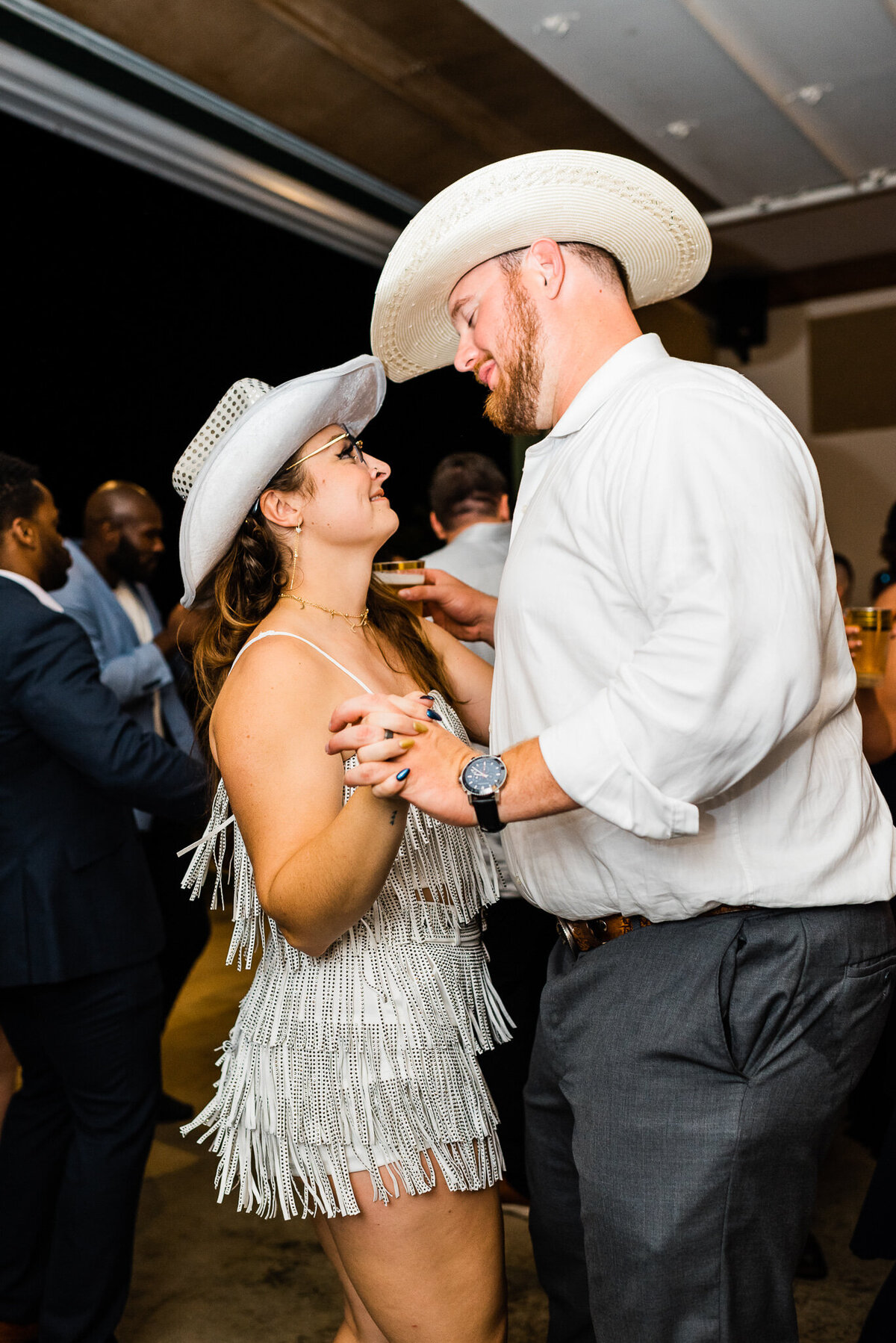 first dance between husband and wife during a cowboy theme wedding reception in Shenandoah wedding venue with bride and groom smiling up to one another