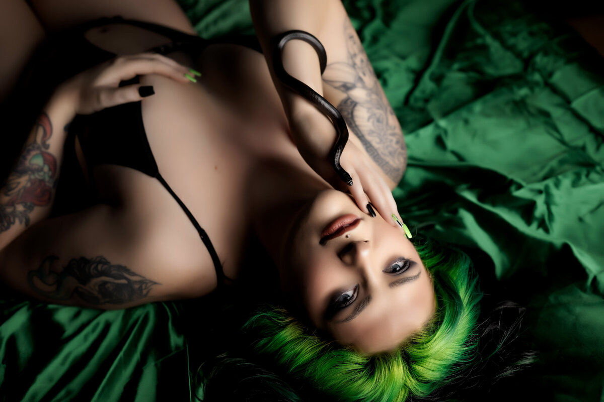 Striking Boudoir Pose with Snake and Green Hair on Emerald Sheets | Joclyn’s Photography