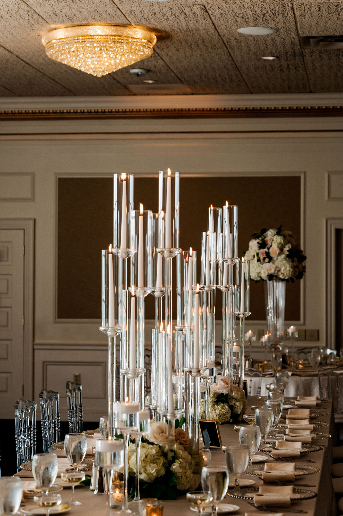 glass wedding candle rentals by sapphire and lace setup at a wedding reception tall centerpieces