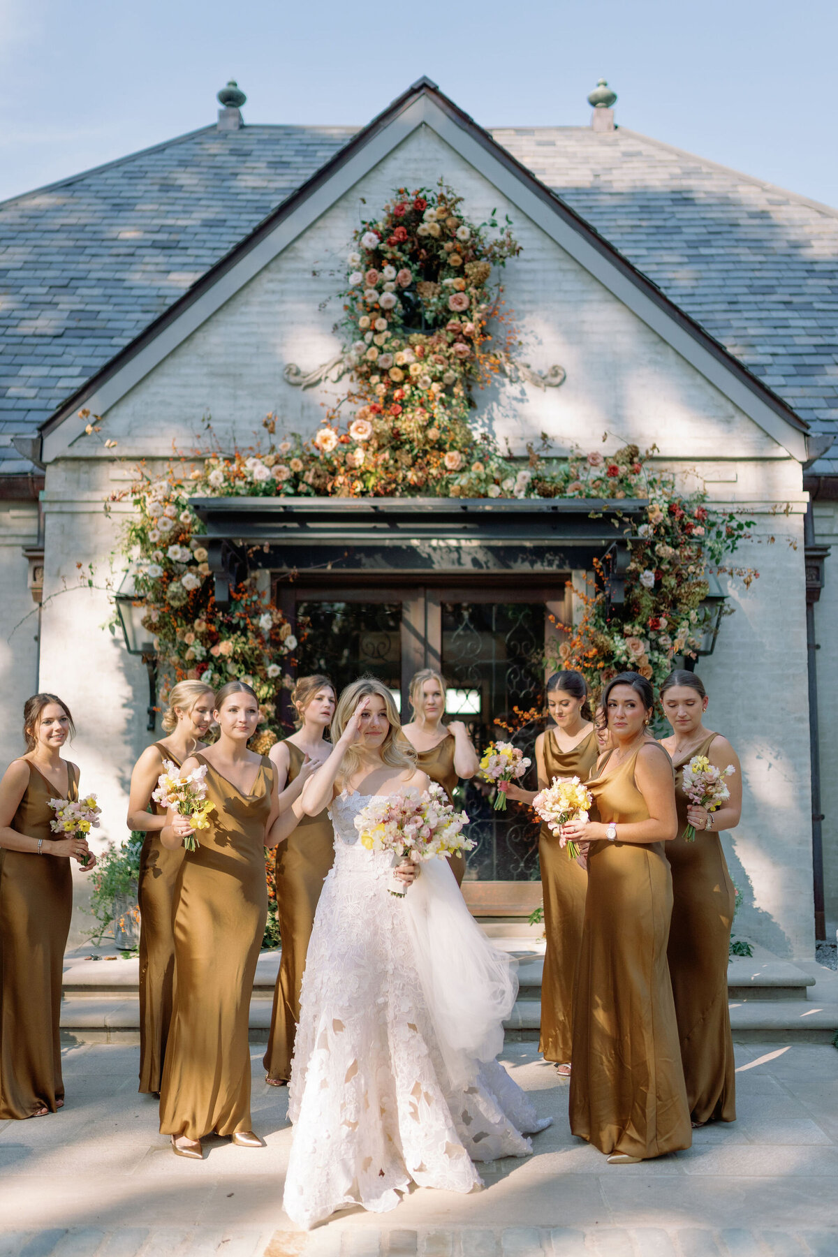 Organic growing floral installation for fall wedding ceremony backdrop. Private residence wedding build out for outdoor wedding ceremony and reception. Whimsical and organic floral design for autumnal wedding in colors of copper, yellow, blush, cream, and pops of orange. Clear tented wedding outside Nashville, TN. Design by Rosemary & Finch Floral Design in Nashville, TN.