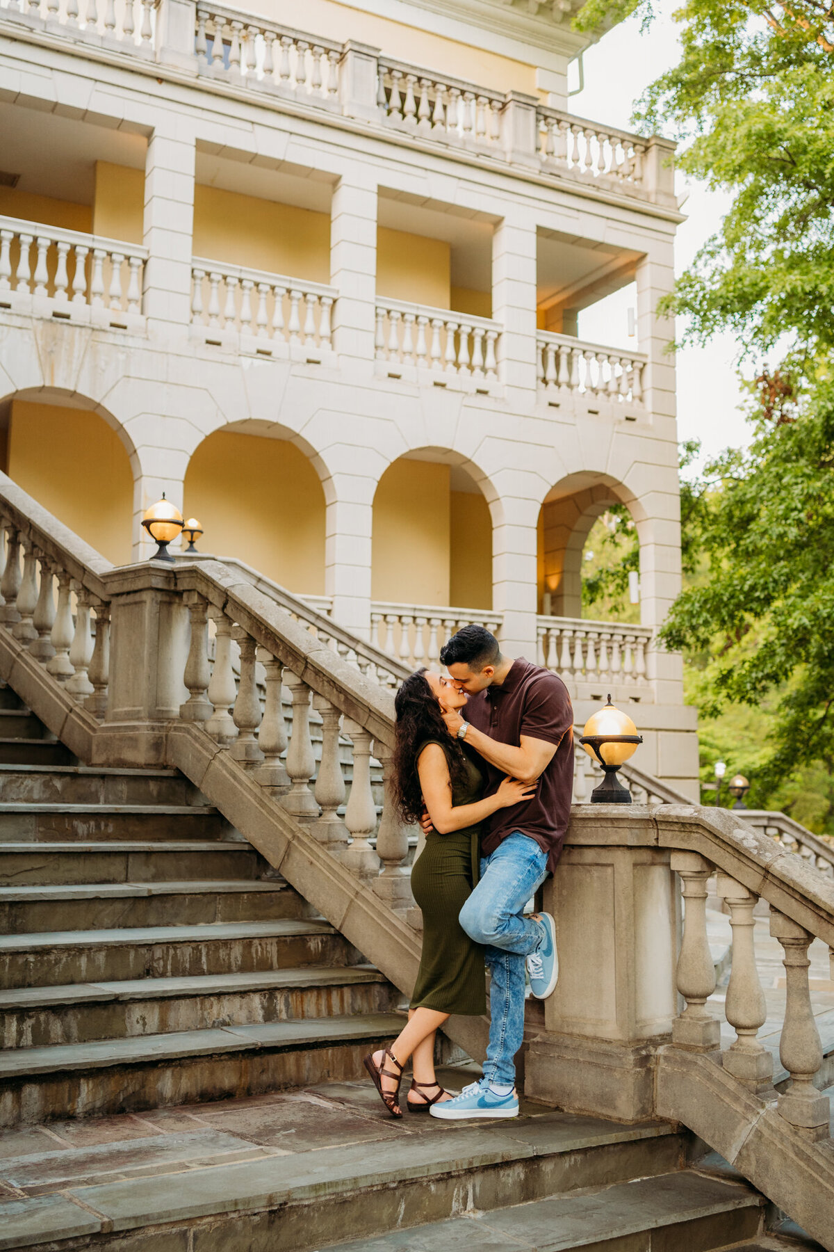 Couple kissing on vintage outdoor staircase at historic venue