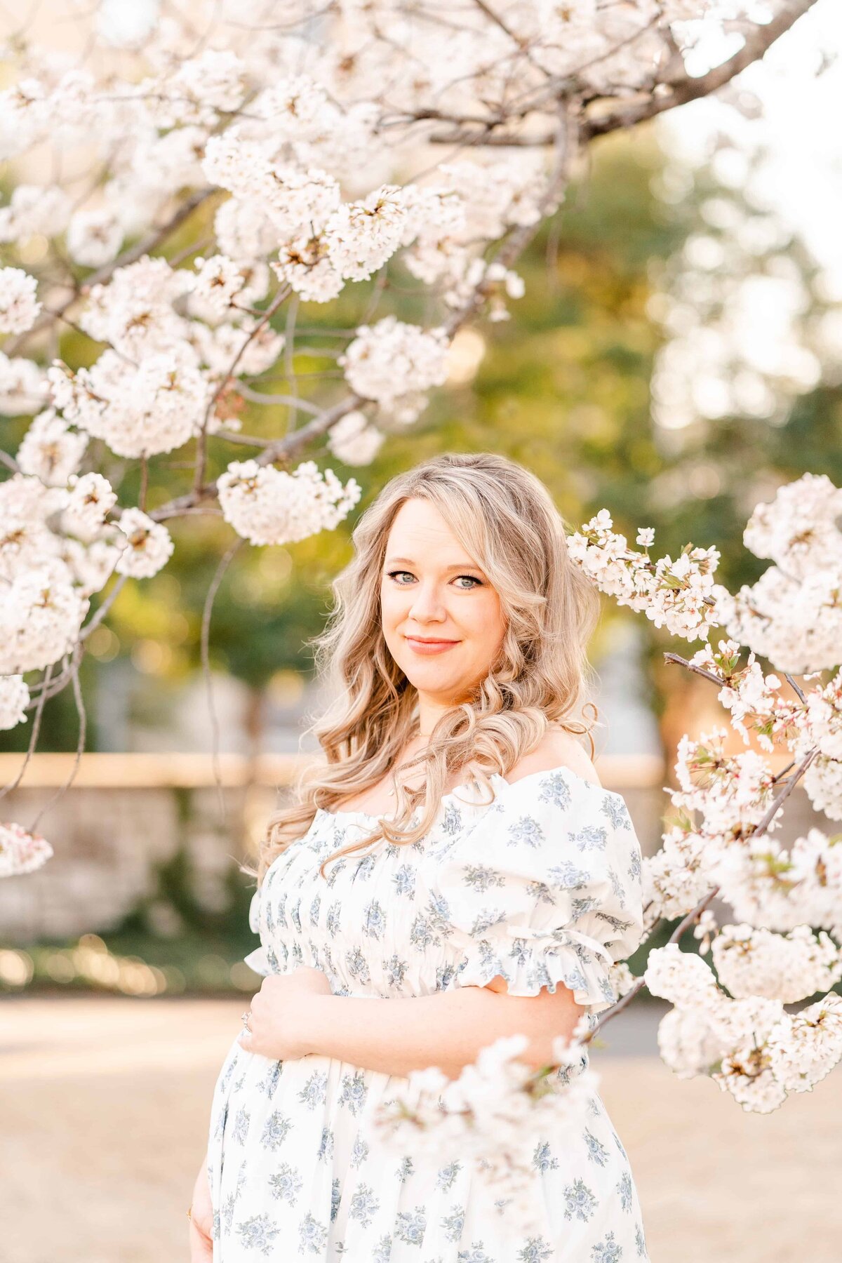 Mother poses with spring cherry blossoms for Chattanooga maternity photographer