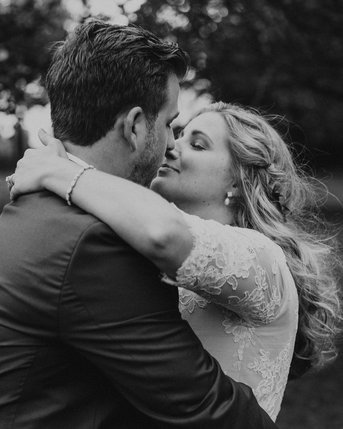 wedding couple kisses during an embrace at John Joseph Inn