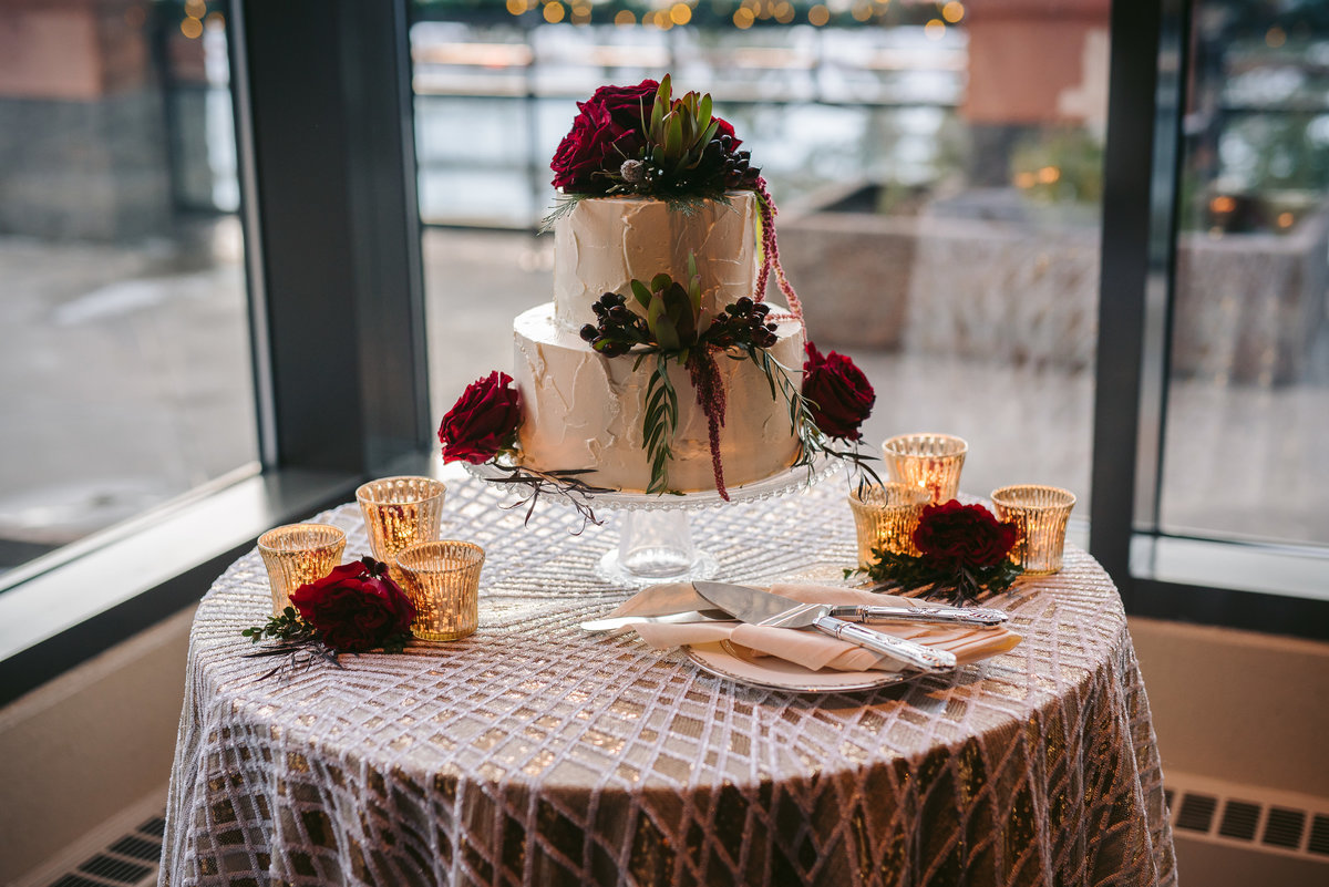 Lake Tahoe Wedding Planners cake table with La Tavola Cher linen burgundy flowers votives at venue The Resort at Squaw Creek, Lake Tahoe, Joy of Life Events image by Charleston Churchill