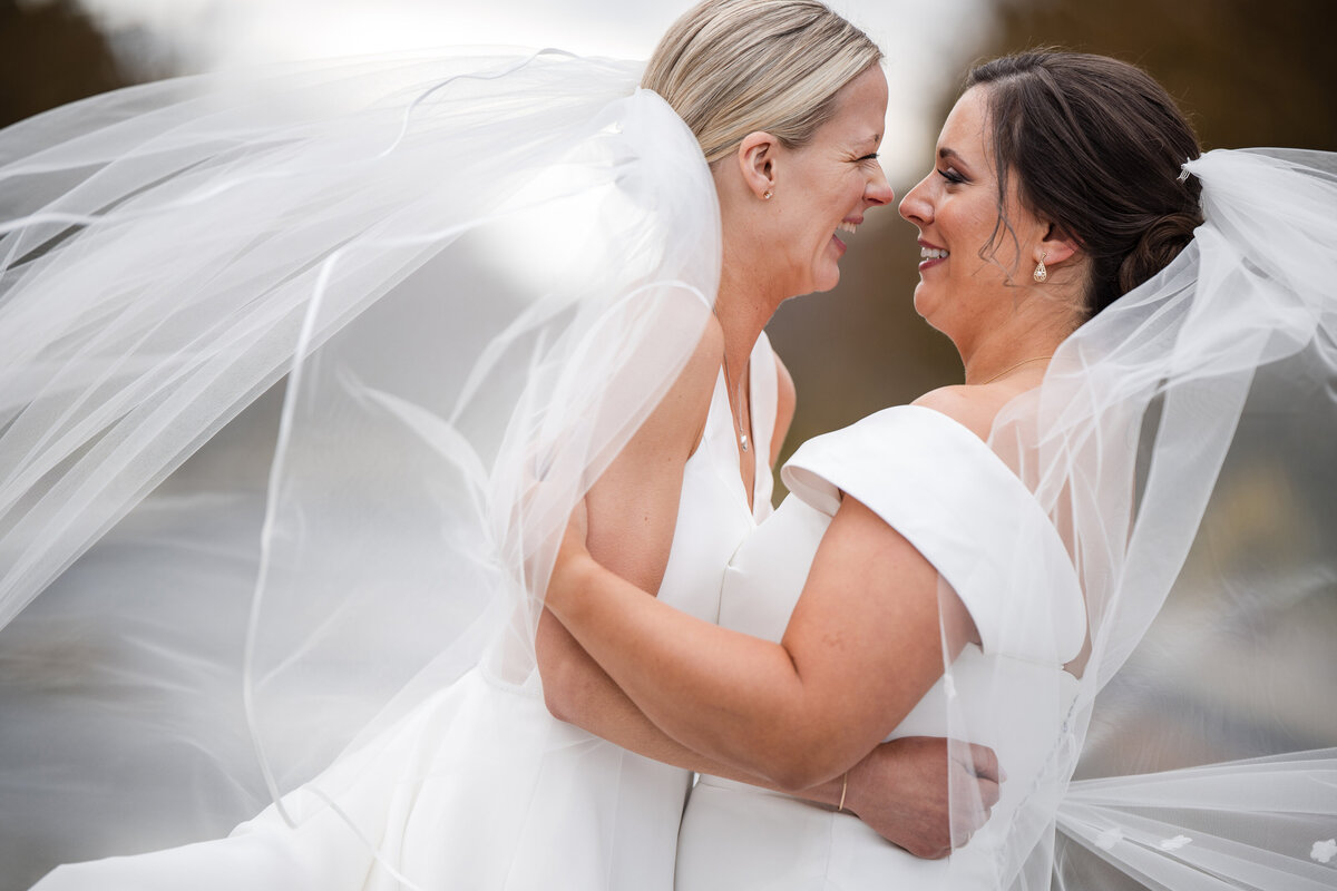 A couple cuddles at a  Fairmount Park Horticulture Center wedding