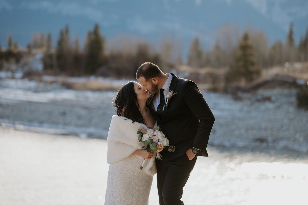 Bride and groom outdoor photo kissing during couples photos at their elopement wedding