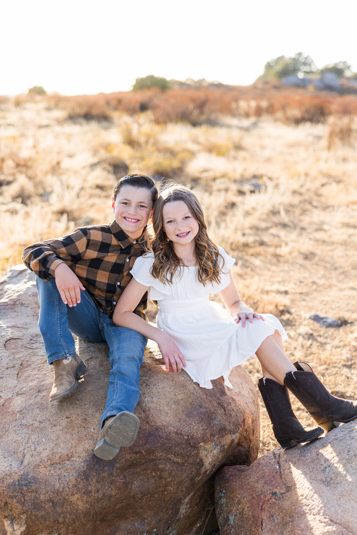 brother and sister sitting on rock wrights field san diego