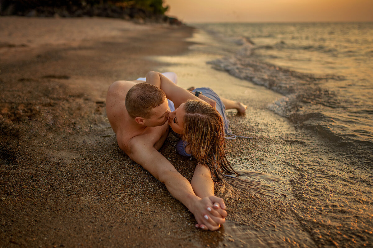 Sexy engagement beach photoshoot  of young couple washed by  lake Michigan waves