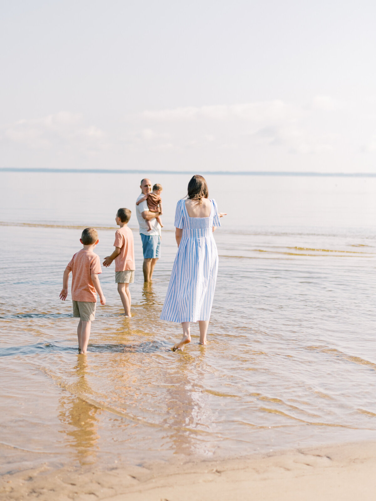 Young family playing in Virginia Beach water.