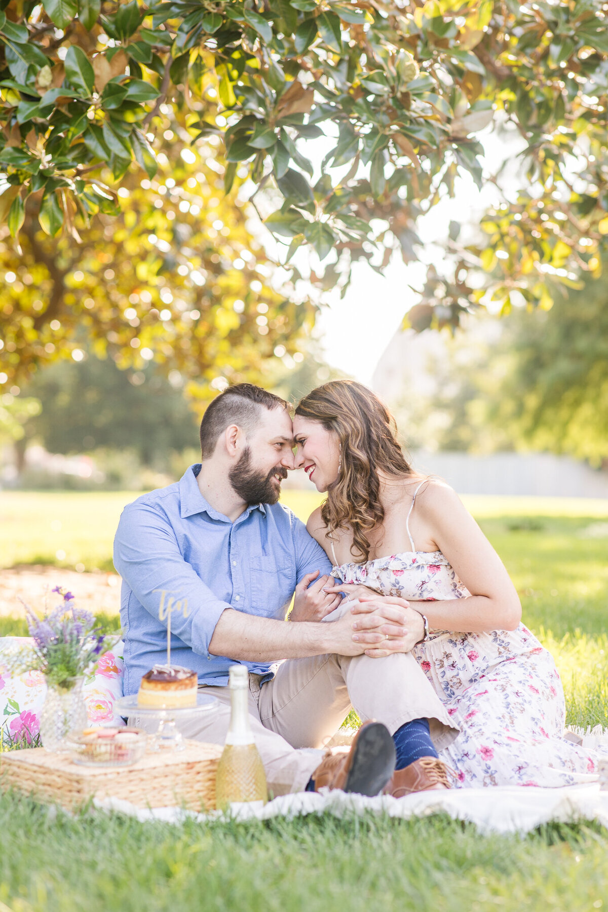 romantic picnic anniversay session couple blue floral dress khakis and blue top