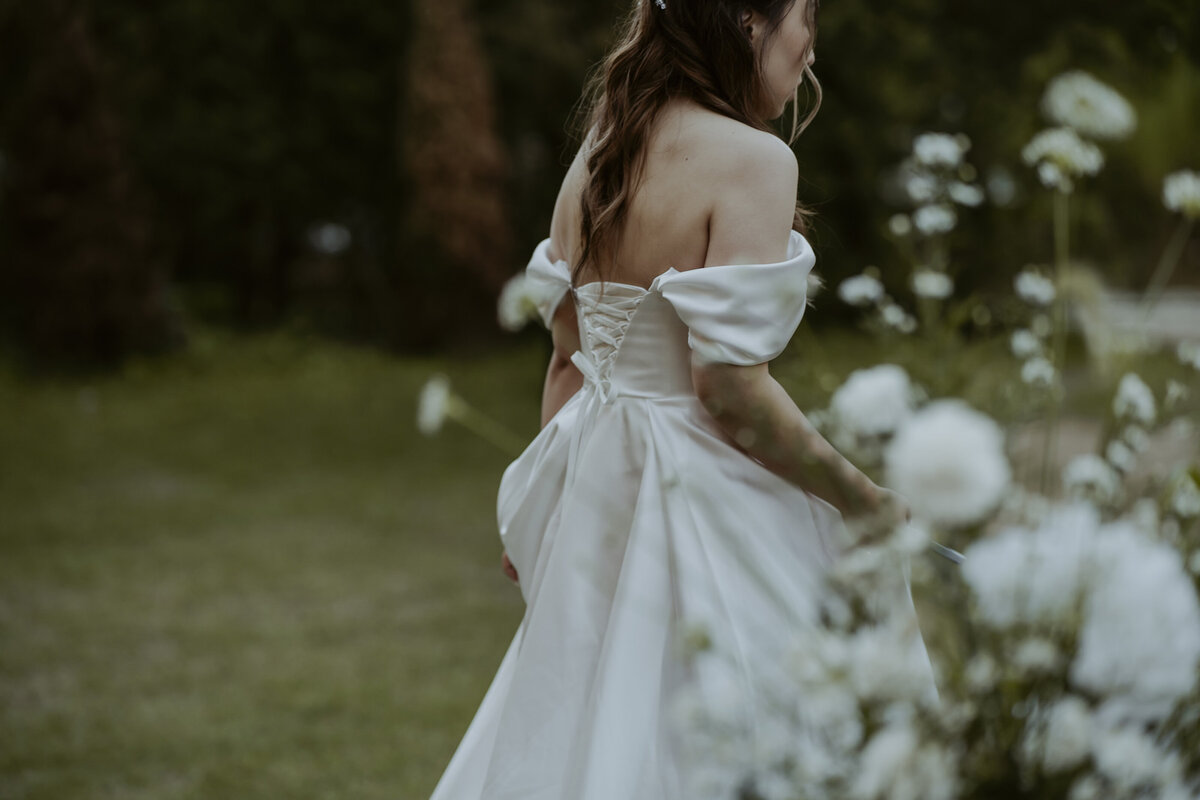 the bride walking and holding her wedding dress