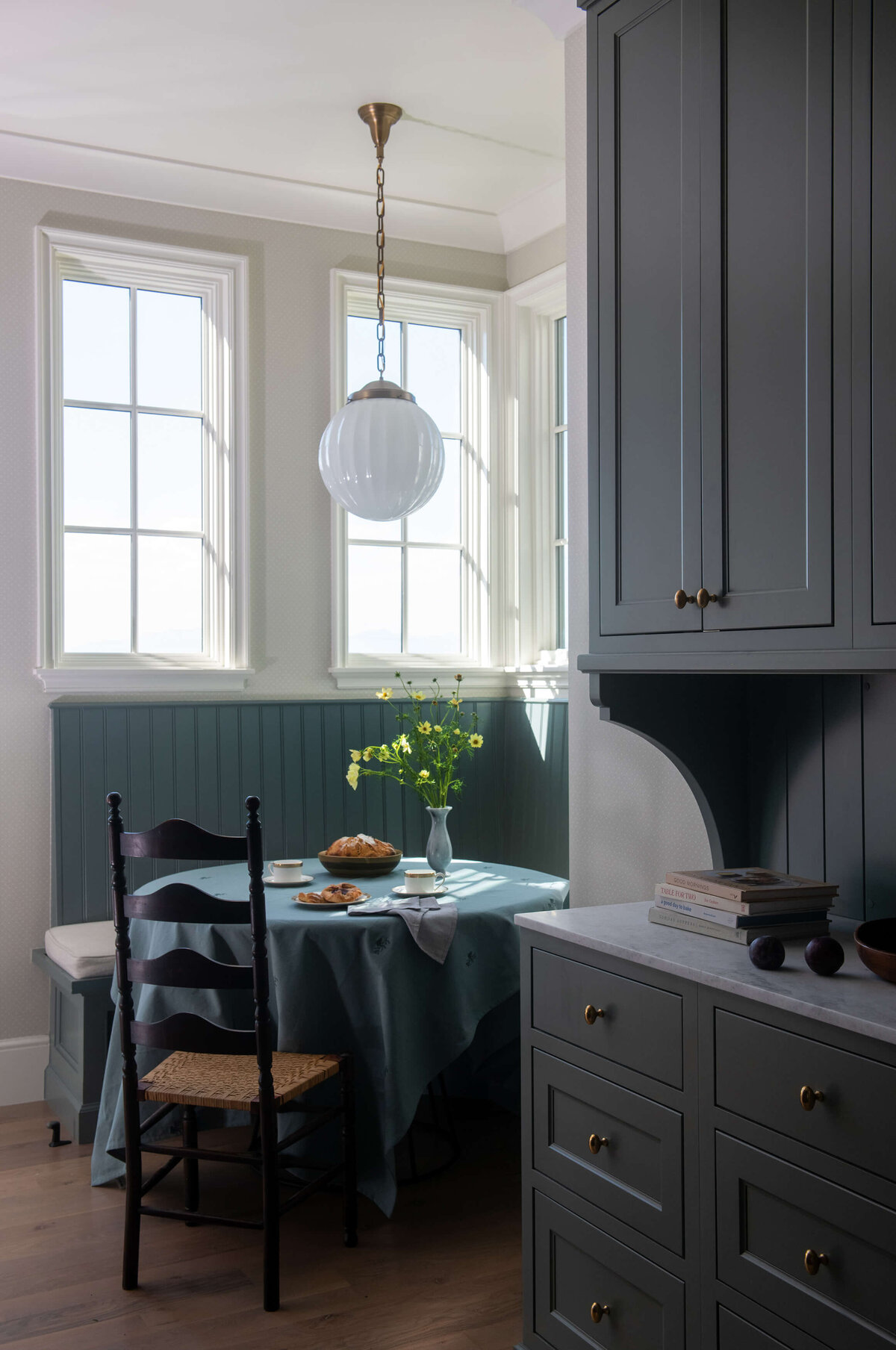 dutch-tudor-breakfast-nook-with-green-paneling-and-window-light