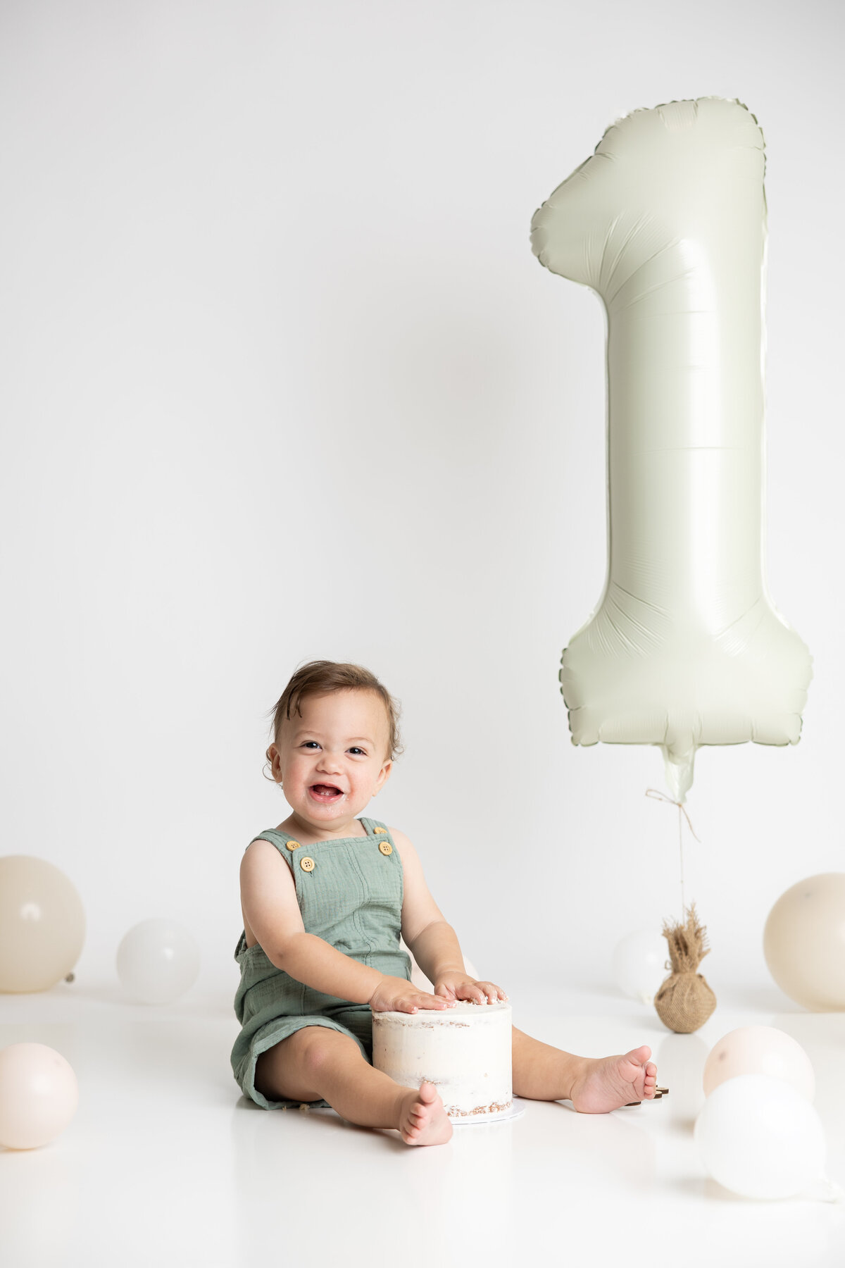 Simple white cake smash with large number one balloon