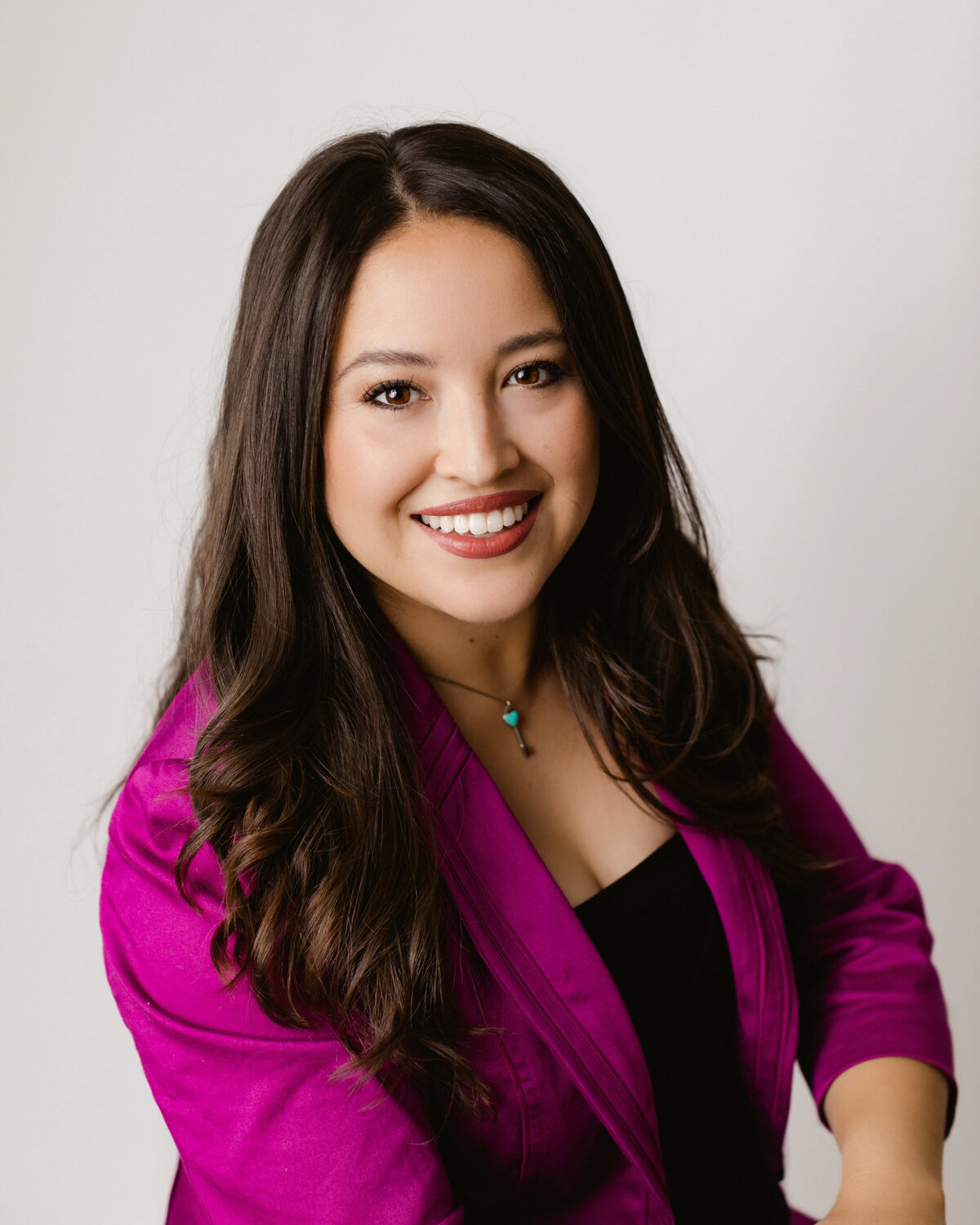Headshot of a woman in a purple blazer