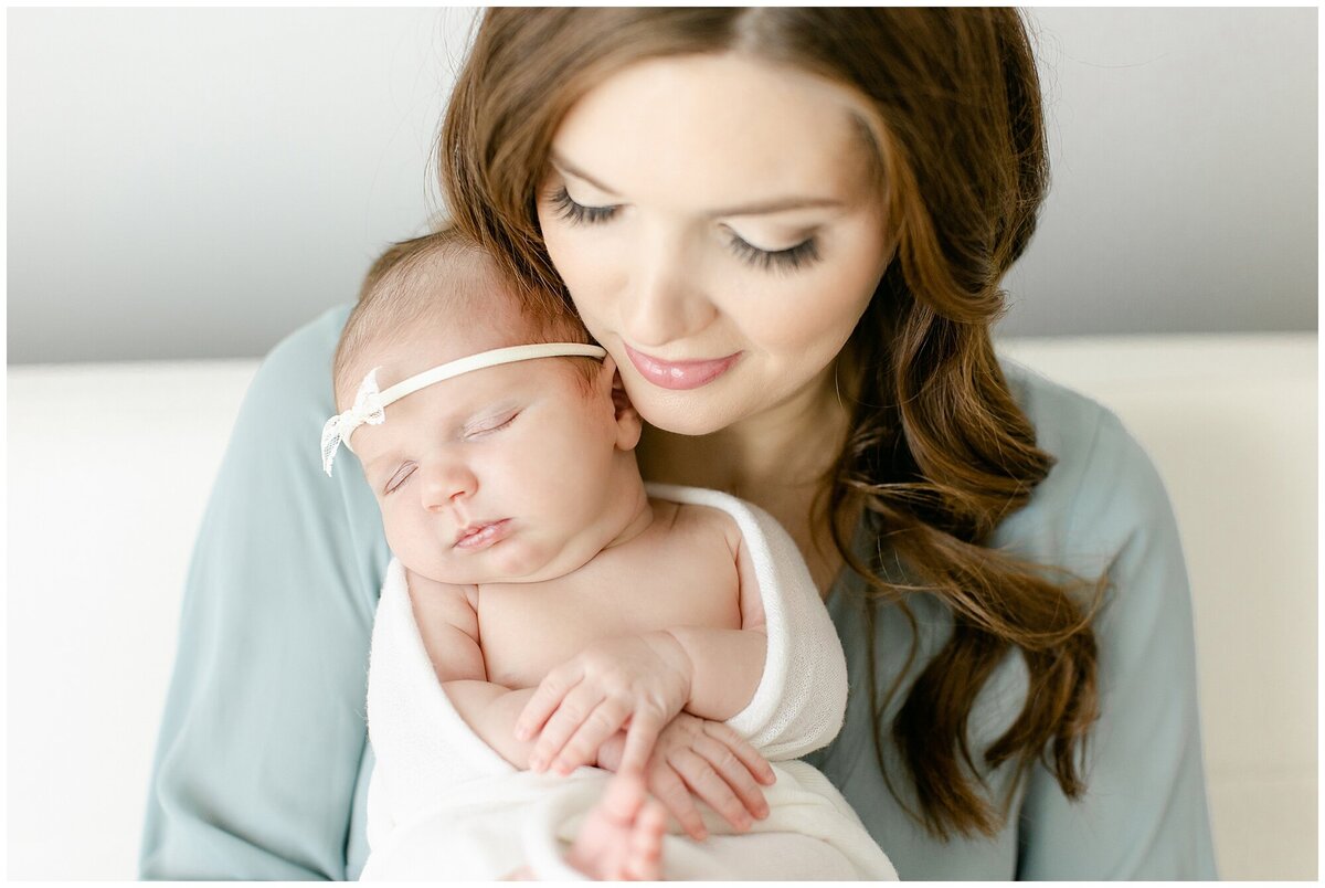 mom holding newborn close to her face