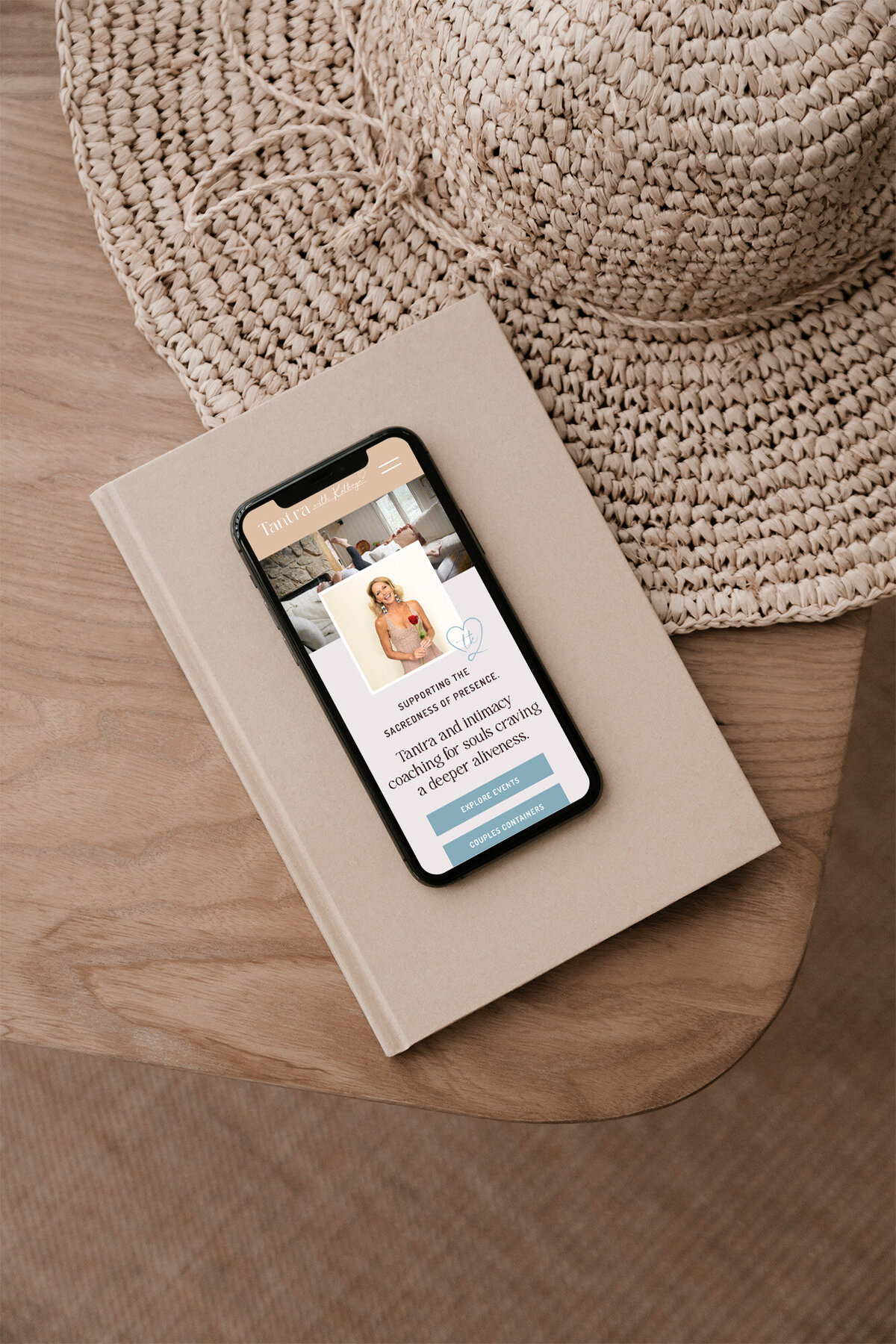 Iphone laying on book open to website for Yoga Instructor