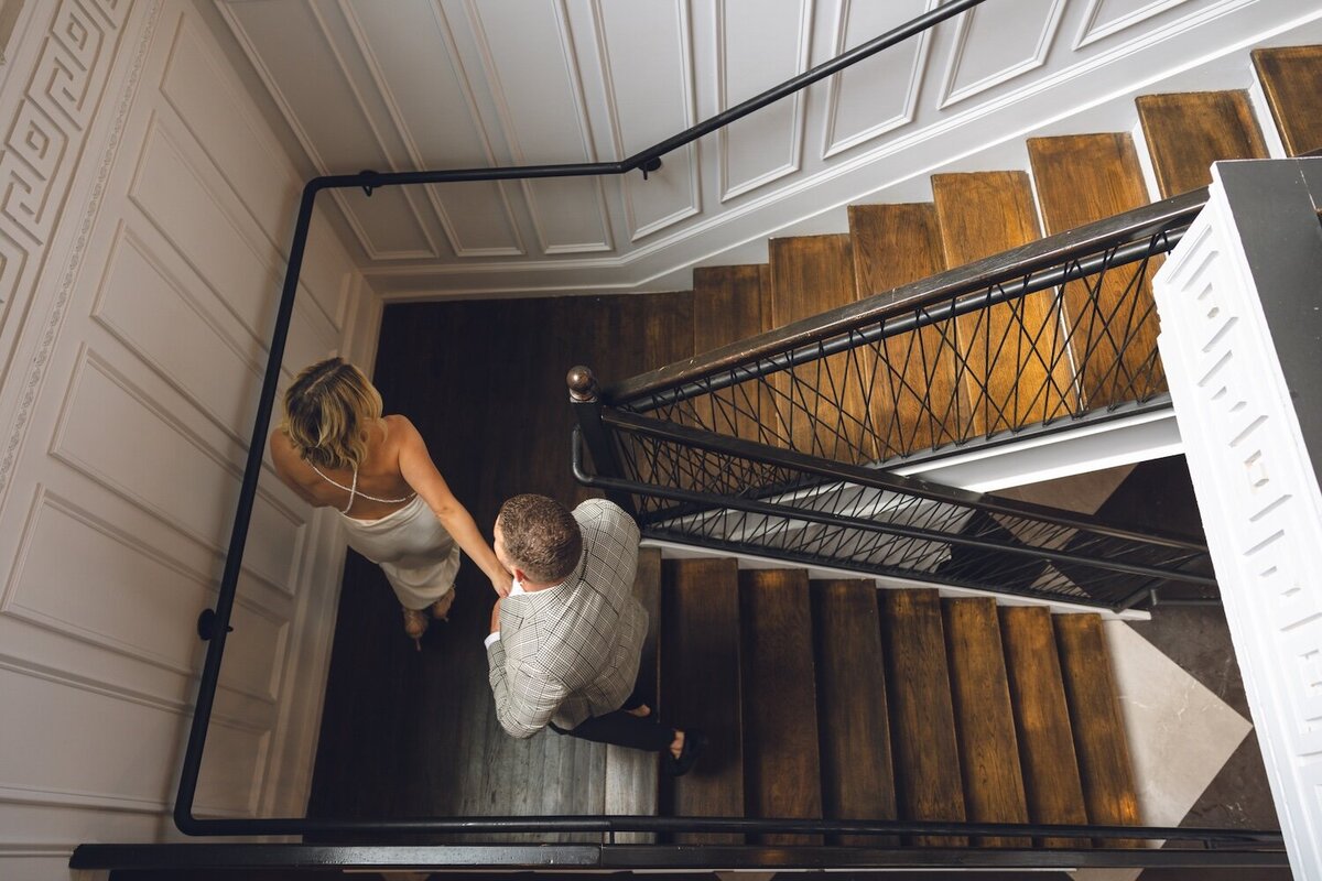 Couple walking up grand staircase inside Felina.