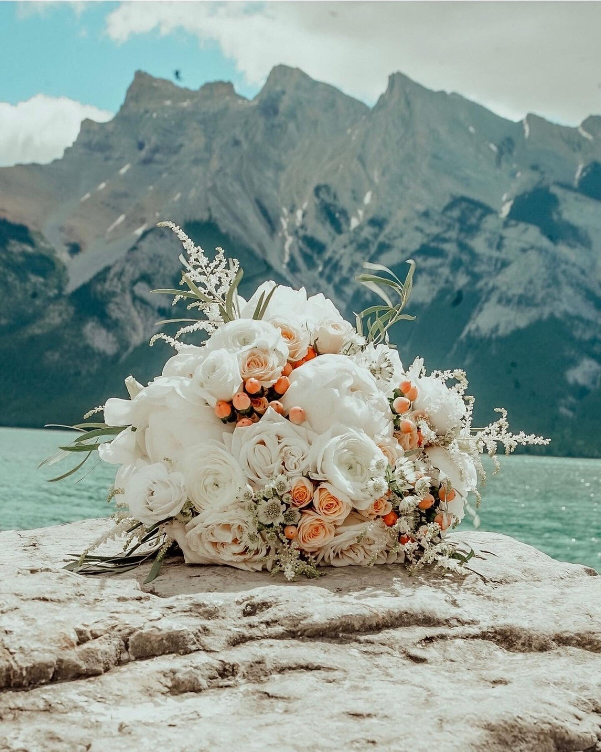Classic bridal bouquet or white roses and pops of peach by Le Bouquet, Calgary wedding florist, featured on the Brontë Bride Vendor Guide.