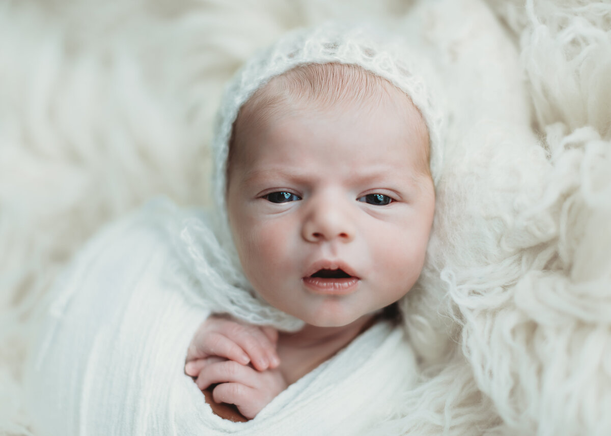awake photos of newborn babies in photography studio in Colorado