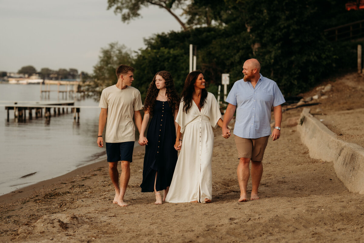 Kenzie Mosher with her husband and kids, illustrating how family inspires her mission to help women feel healthy, confident, and energized.