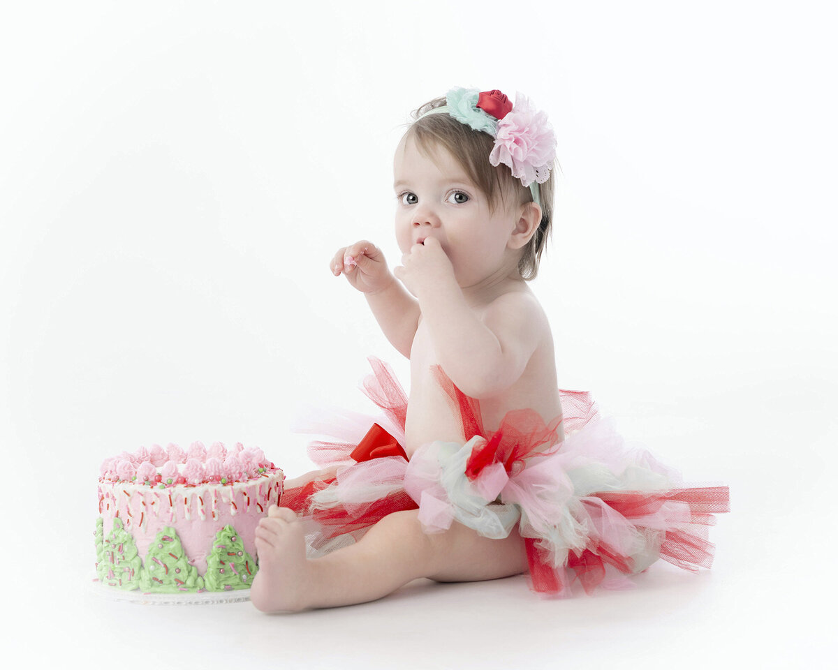 Little girl eats cake for her Iowa Milestone Photograph