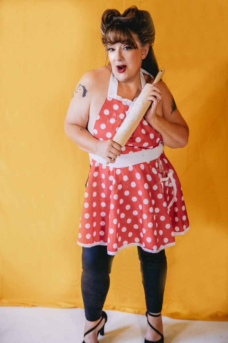 Pinup woman in polkadot red apron and yellow background in Minneapolis Mn