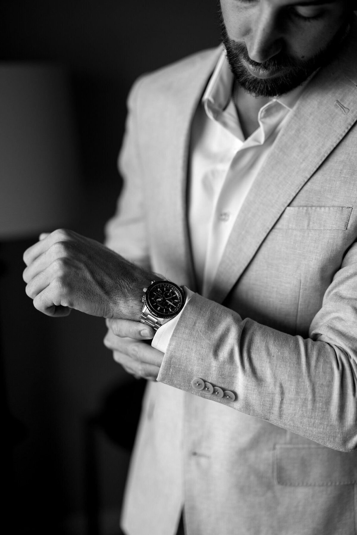 Groom adjusting watch getting ready for wedding at Hilton Beachfront Resort Santa Barbara