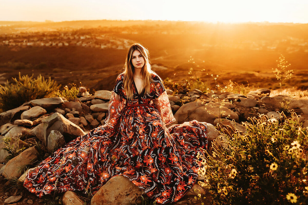 High school senior girl in a  handmade gown on the Estes Park mountains at sunset.