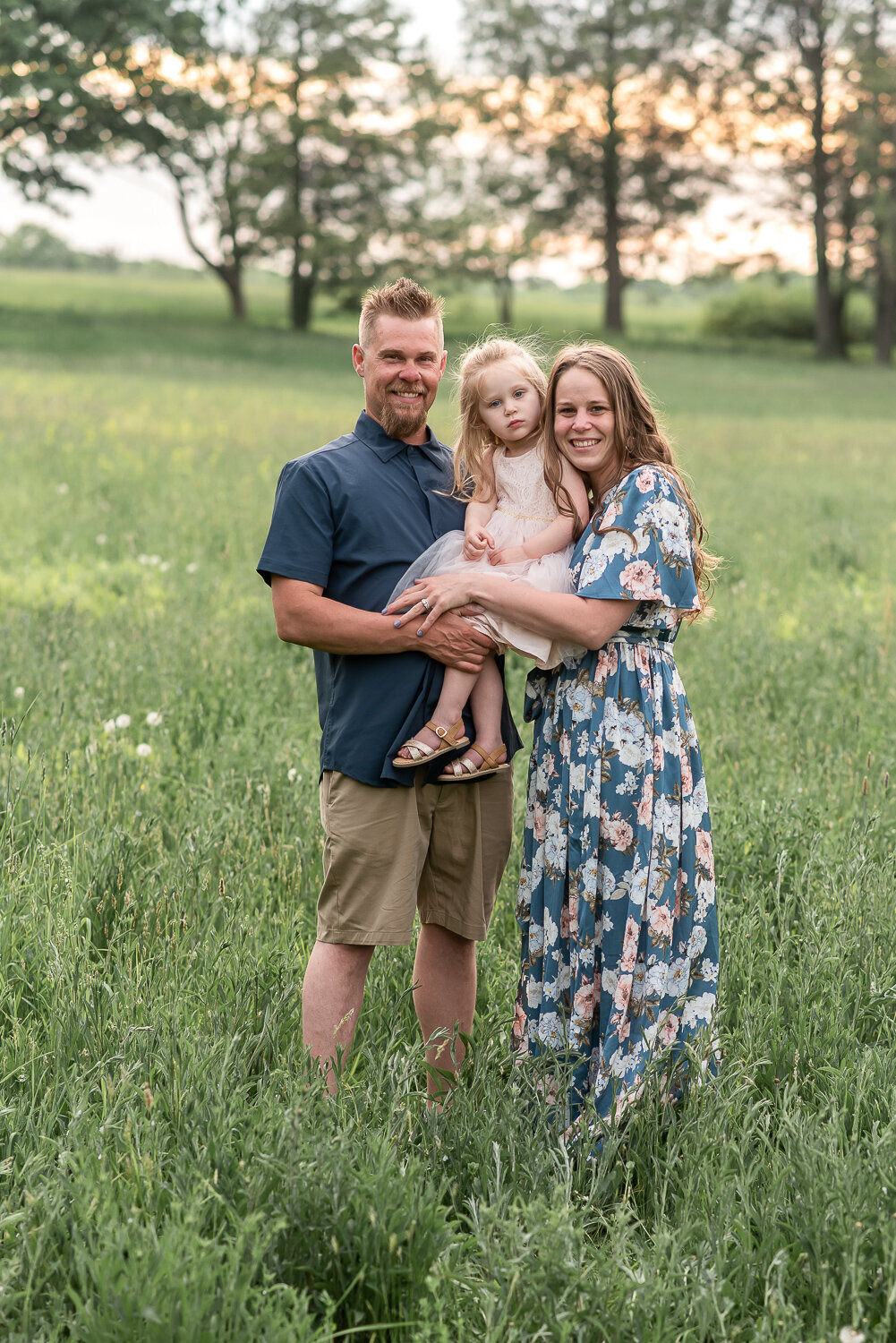 Family of three smiling at camera for family photo shoot at sunset |Sharon Leger Photography | Canton, CT Newborn & Family Photographer