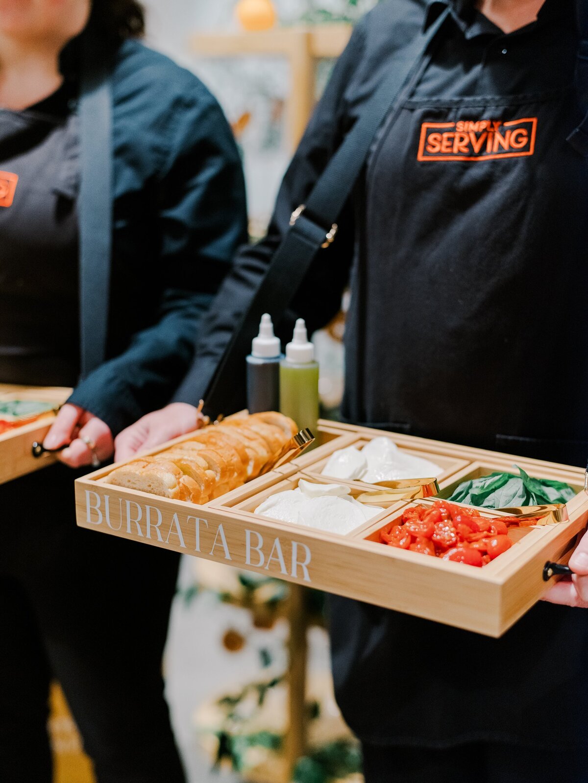 Caterer passing appetizers for burrata bar