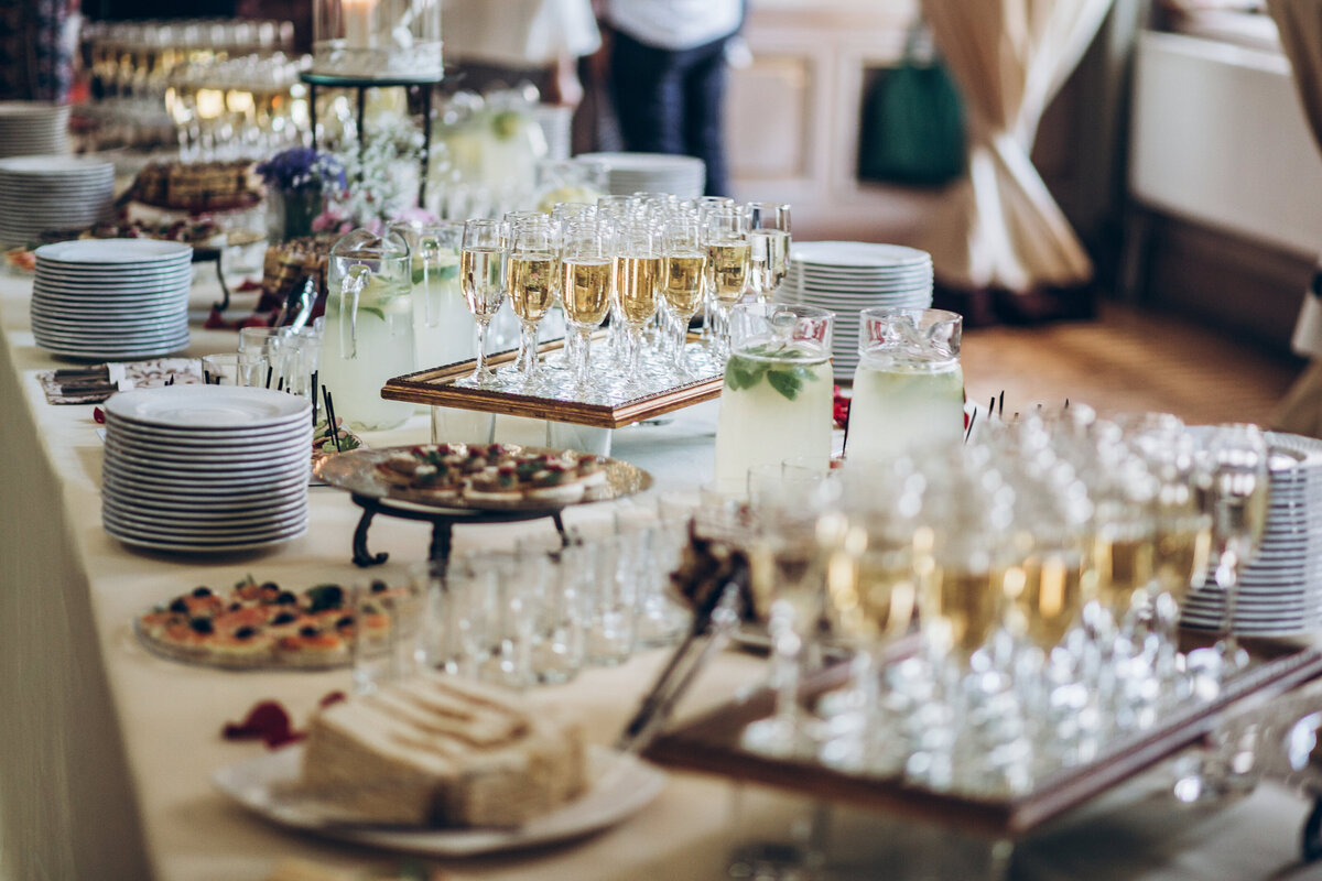 A buffet table with appetisers, cocktails and champagne.