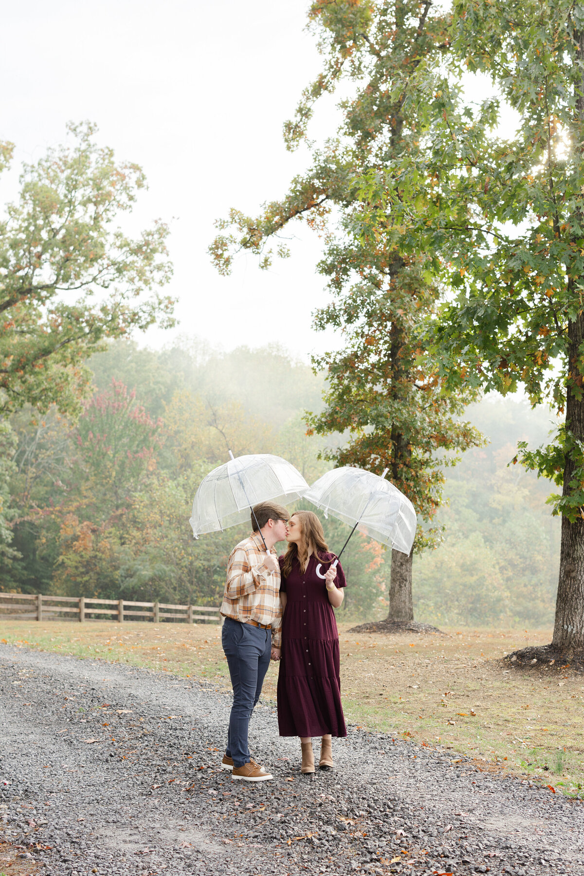 couple posing under an umbrella during rainy session in Cleveland, TN