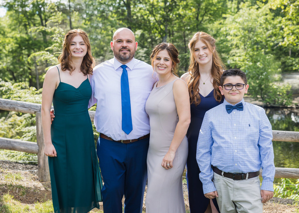 Family all standing together in formal wear smiling