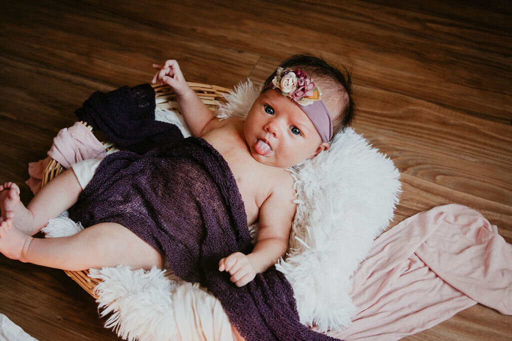 Newborn baby pulling a silly face